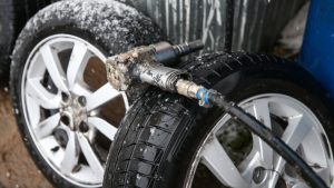 Image of Car tires close-up wheel placed on the road on dusky cloud background