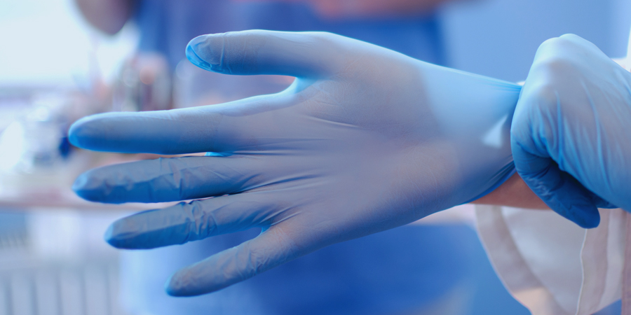 Image of a man wearing rubber cloves